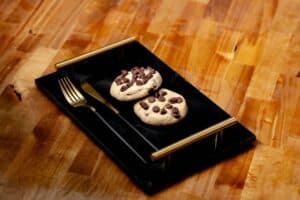 Two cannabis-infused cookies on a plate, representing strong edibles for beginners to dose carefully.