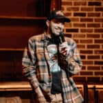 A smiling comedian on stage