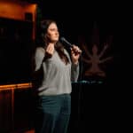 A comedian telling jokes on a Chronic Guru stage